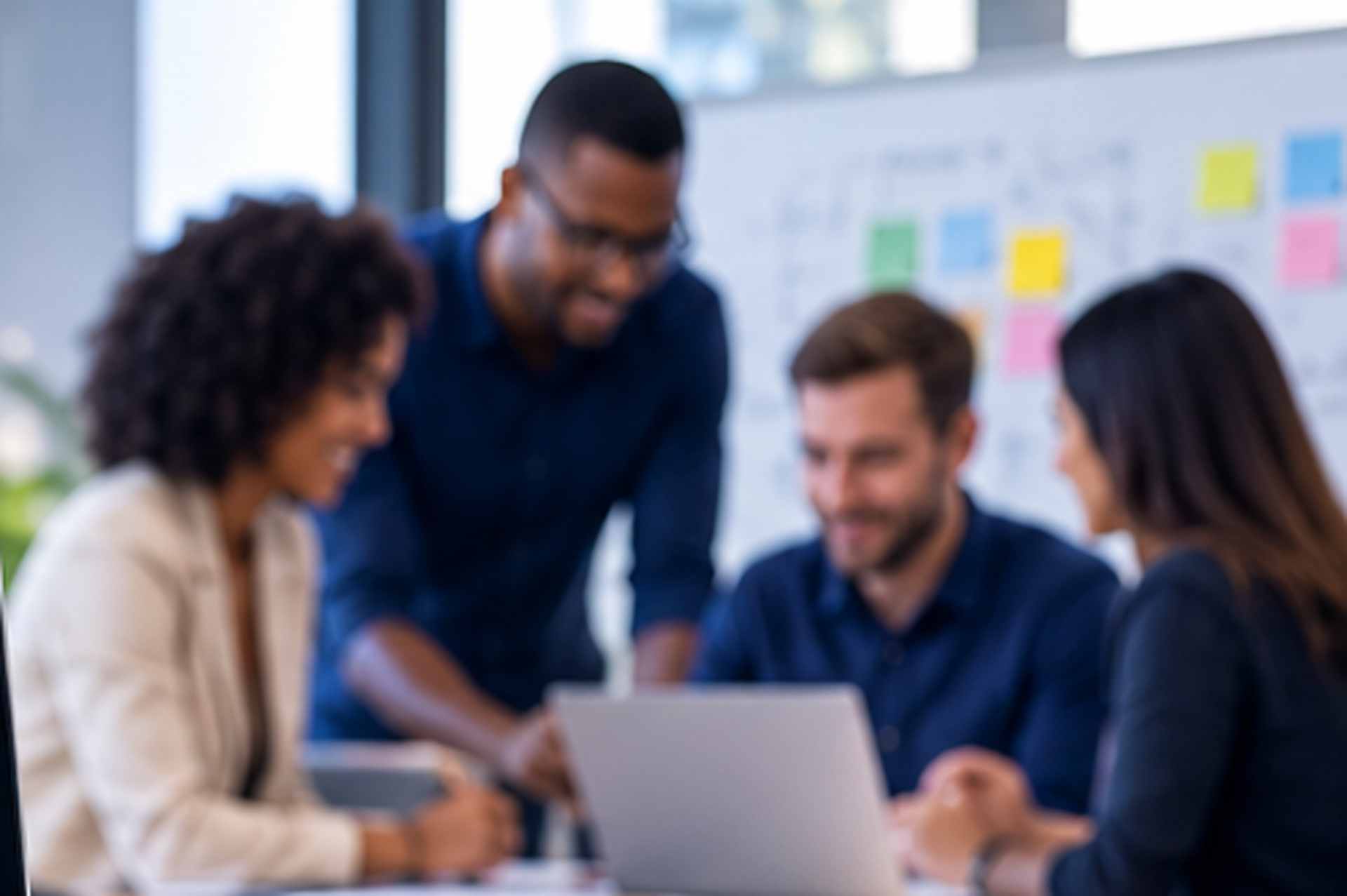 A team gathered around a laptop during a project planning session